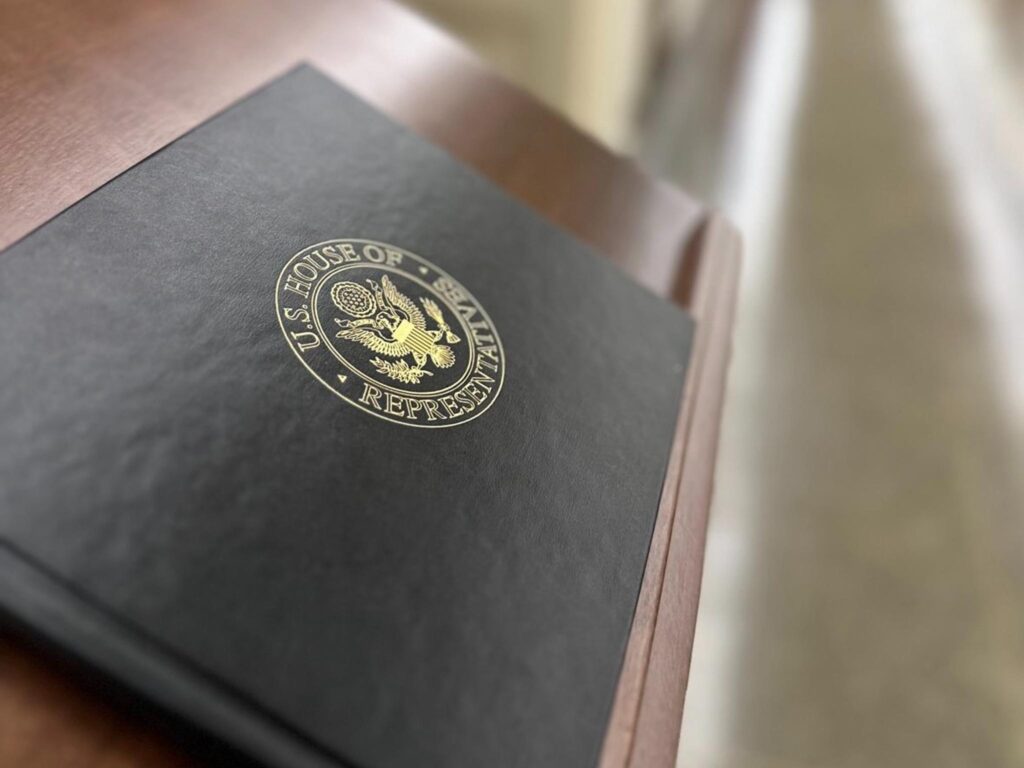 Black book with "House of Representatives" on the front.